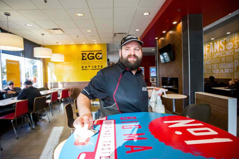 MIKAELA MACKENZIE / WINNIPEG FREE PRESS
Edward Case, an adult living with special needs, cleans tables and mops floors at the McDonald’s restaurant on Henderson Highway.