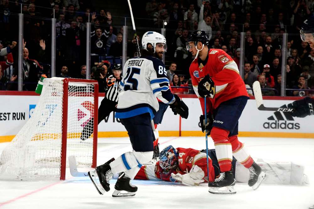 Heikki Saukkomaa / Lehtikuva / The Associated Press
Jets forward Mathieu Perreault (above, left) celebrates after scoring during Game 1 of the NHL Global Series.