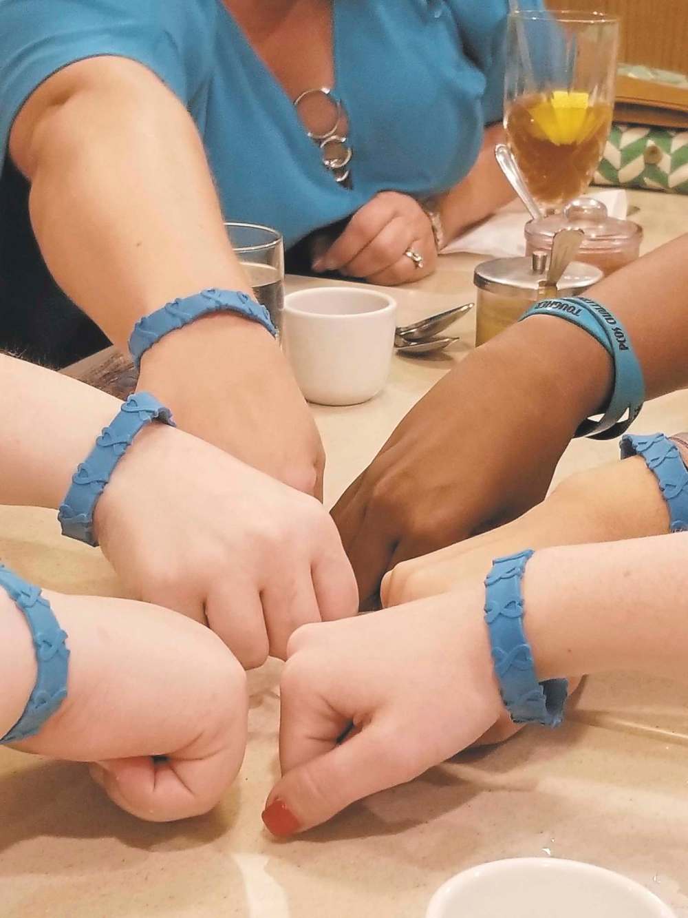Ashley Levinson photo
PCOS patients-turned-advocates wear teal wristbands to raise awareness of their disorder.
