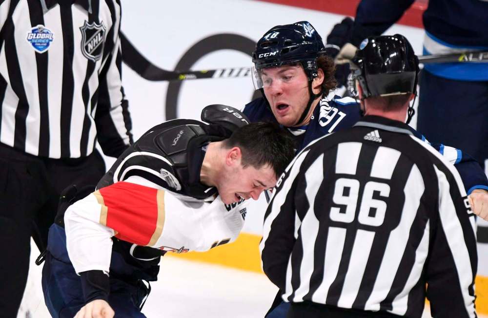 Martti Kainulainen via Lehtikuva / The Canadian Press files
MacKenzie Weegar of the Florida Panthers (left) and Brendan Lemieux fight during the NHL Global Series Challenge Friday in Helsinki.