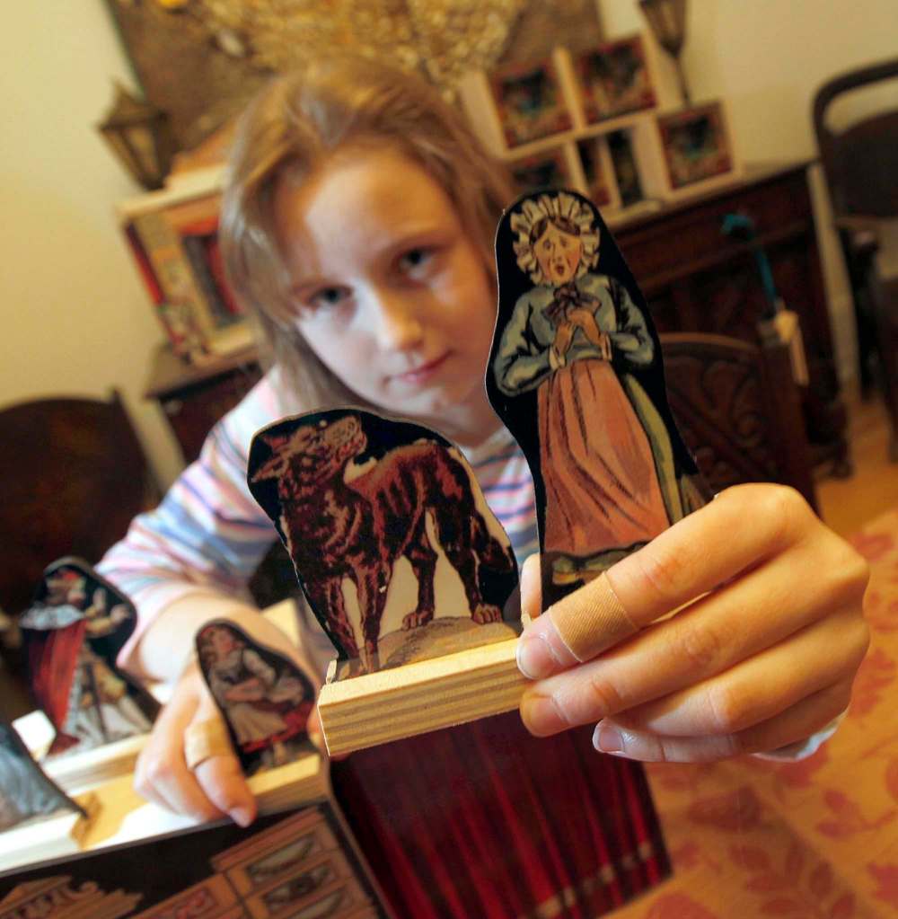 Laine Wilding shows off an assortment of Wooden Squirrel’s Dream Theatre figurines.
