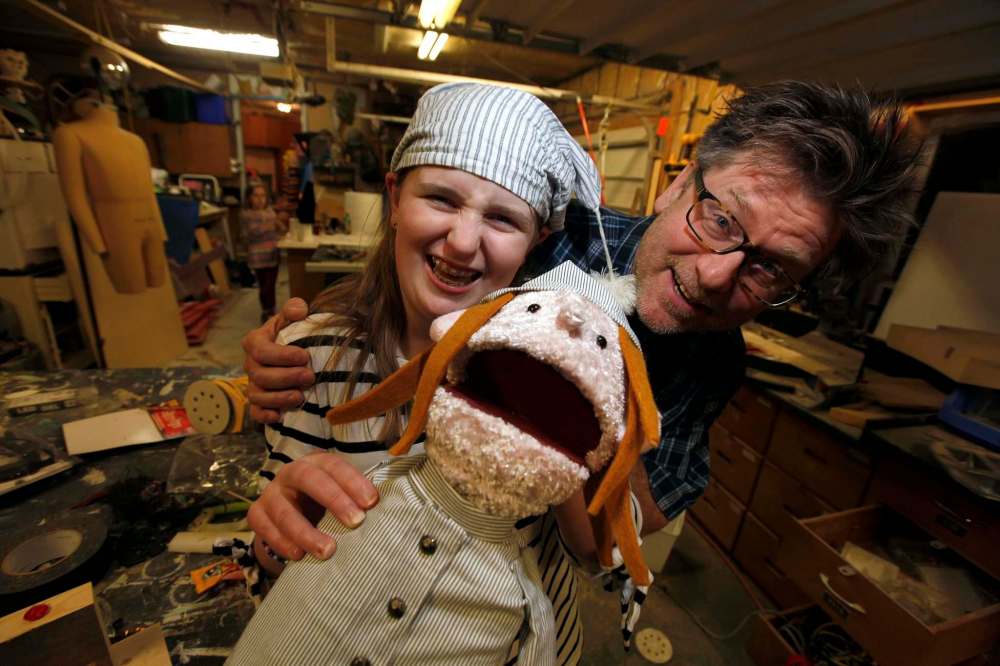 Jasper Lily, dad Gord Wilding and a puppet pal share a laugh in the Wooden Squirrel toy workshop.