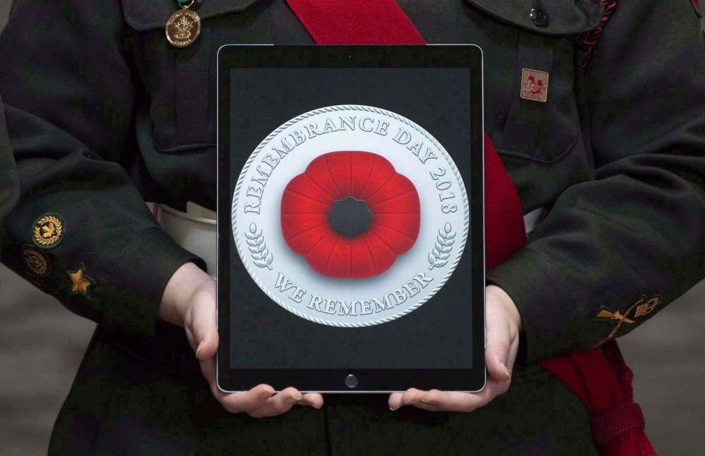 A tablet displays a digital poppy Canadians can post on social media. (Adrian Wyld / The Canadian Press files)