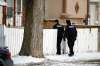 PHIL HOSSACK / WINNIPEG FREE PRESS
Two police officers enter the front walkway at 335 Bannerman Ave. on Friday. The house was the site of a five-hour standoff on Wednesday. A 16-year-old has been charged.