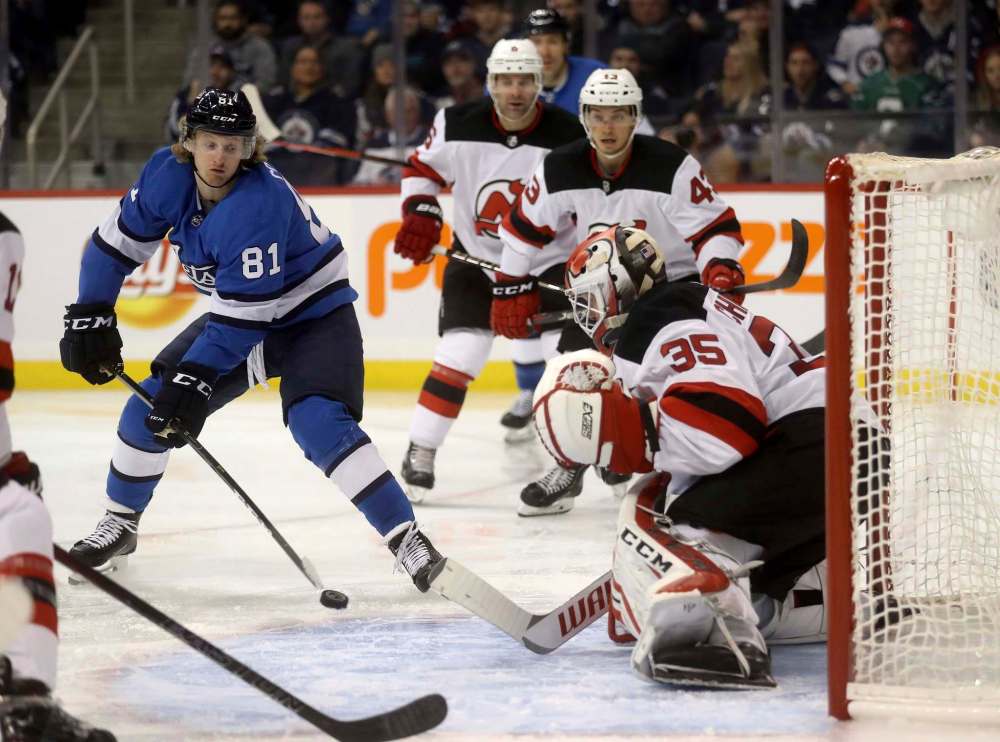TREVOR HAGAN / THE CANADIAN PRESS
Winnipeg Jets' Kyle Connor (81) fires a shot on New Jersey Devils goaltender Cory Schneider (35) during second period NHL hockey action in Winnipeg, Sunday, November 11, 2018.