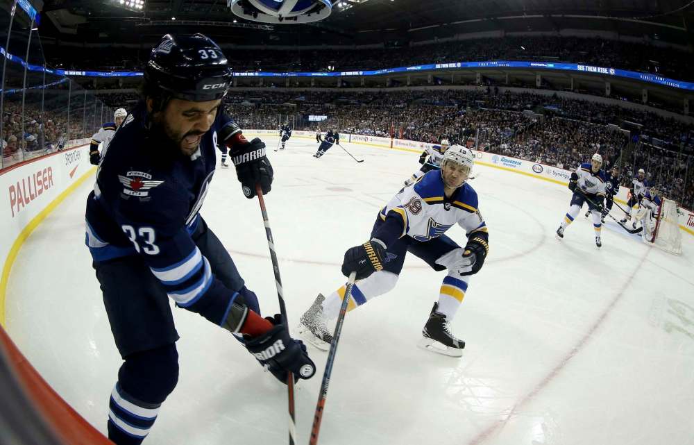 Dustin Byfuglien is known for his physical game and Ben Chiarot is glad to be playing with him, rather than against him. (Trevor Hagan / The Canadian Press files)