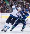 Darryl Dyck / The Canadian Press files
Jets forward Blake Wheeler (left, alongside Canucks’ Derrick Pouliot) will be celebrating U.S. Thanksgiving in Minnesota with his family.