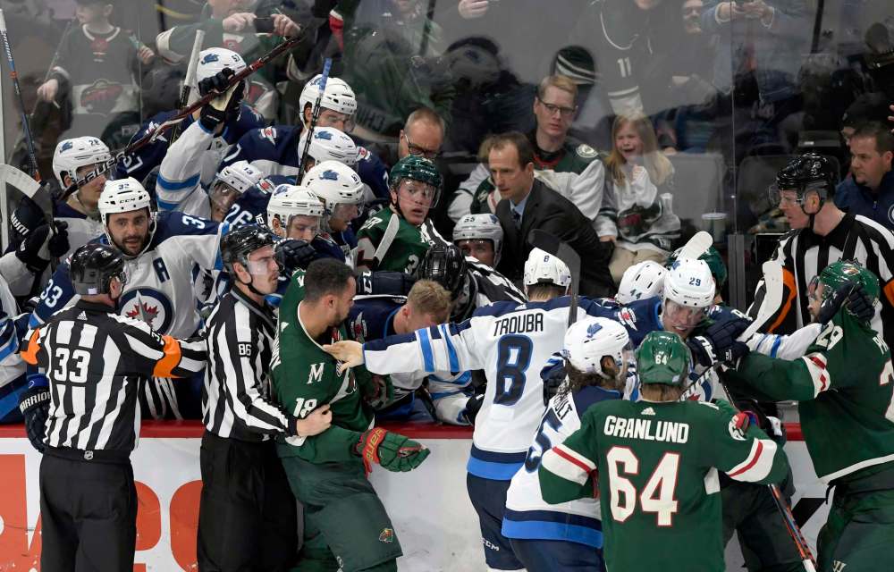 Hannah Foslien / The Associated Press
Minnesota Wild and Winnipeg Jets players scuffle at the Jets’ bench during the third period of Friday’s game in St. Paul, Minn. The Wild won 4-2.