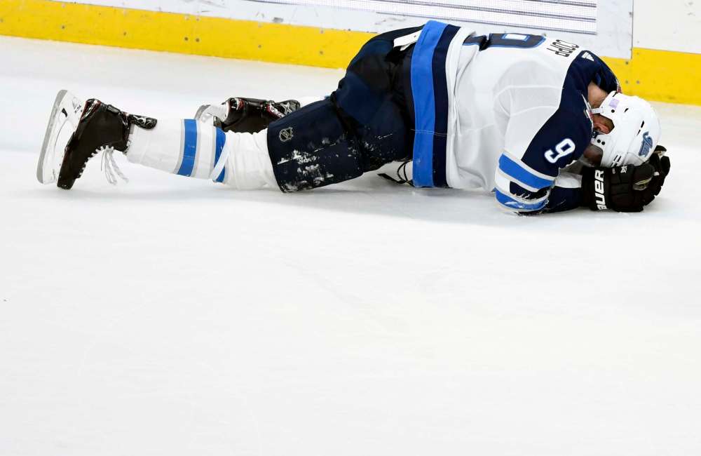 Hannah Foslien / The Associated Press
Winnipeg Jets's Andrew Copp (9) lays on the ice after a check by Minnesota Wild's J.T. Brown (23), not pictured, during the third period of an NHL hockey game Friday, Nov. 23, 2018, in St. Paul, Minn. Copp left the game. The Wild won 4-2.