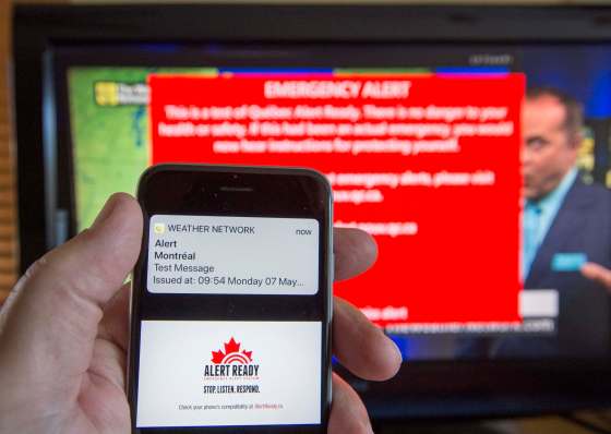 A smartphone and a television receive visual and audio alerts to test Alert Ready, a national public alert system Monday, May 7, 2018 in Montreal. (Ryan Remiorz / The Canadian Press files)