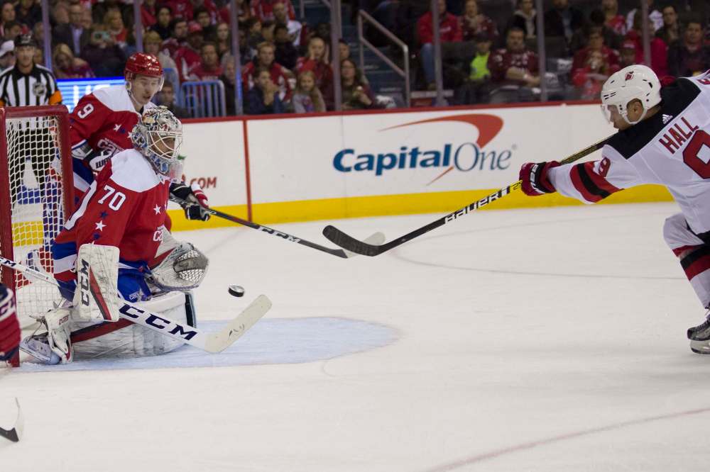 Washington Capitals goaltender Braden Holtby blocks a shot by New Jersey Devils left wing Taylor Hall Friday/ (Alex Brandon / The Associated Press)