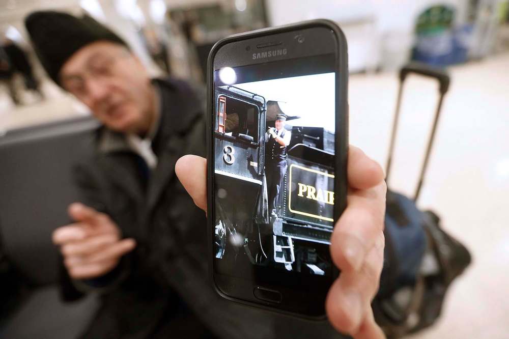 JOHN WOODS / WINNIPEG FREE PRESS
Doug Belcher shows a photo of him as a train conductor on the Prairie Dog Central.