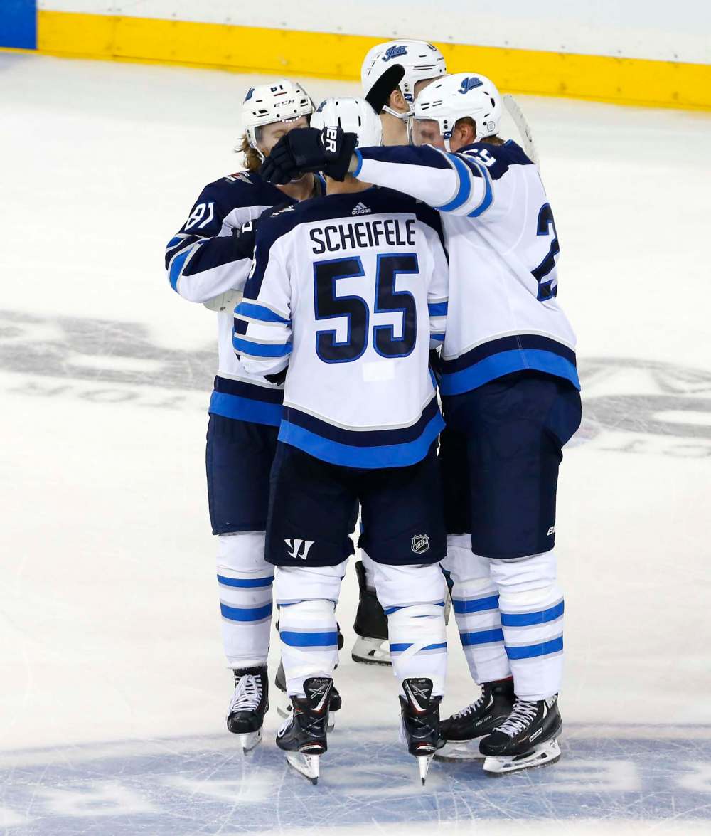 Winnipeg Jets centre Mark Scheifele (55) celebrates after scoring the winning goal against the New York Rangers during a shoot out of an in New York. The Jets won 4-0. (Noah K. Murray / The Associated Press)