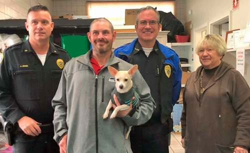 Sumner Police Department
Sumner police Deputy Chief Jeff Engel (from left) stands with Kevin Booth (holding Bella, his friend&rsquo;s dog), Sumner police Chief Brad Moericke and food bank director Anita Miller.