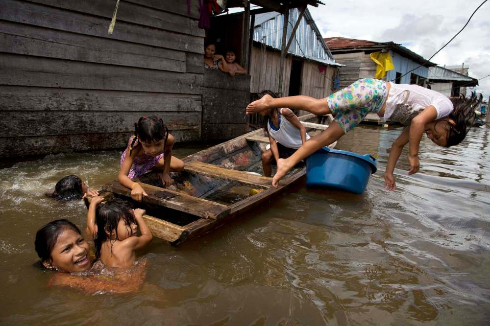 Rodrigo Abd / The Associated Press Files
Peruvian children play in the Amazon community of Iquitos, which is nicknamed Venice of the Jungle because canoes are the most popular form of transport.