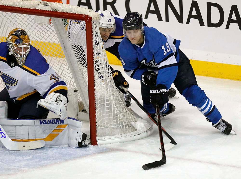 Phil Hossack / Winnipeg Free Press
Tanev wraps around St Louis Blues net minder Jake Allen Friday night at Bell MTS Place.