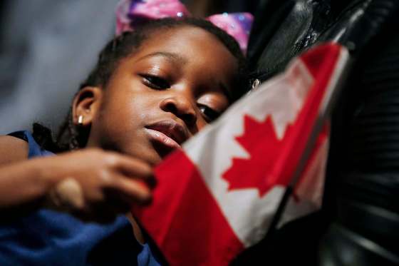 John Woods / Winnipeg Free PressChristine Bazie looks at her flag during a citizenship ceremony at the Canadian Museum for Human Rights Sunday. It was part of the celebration of the 70th anniversary of the United Nations Universal Declaration of Human Rights.