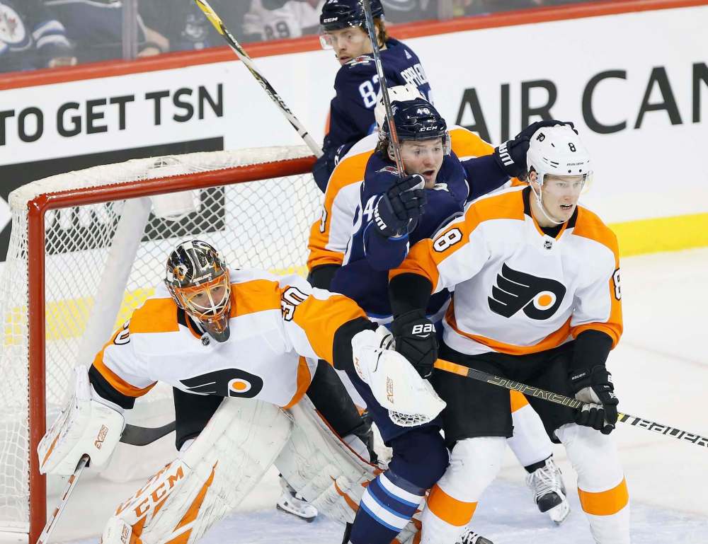 JOHN WOODS / WINNIPEG FREE PRESS
Winnipeg Jets' Brendan Lemieux (48) tries to get open in front of Philadelphia Flyers goaltender Michal Neuvirth (30) as Robert Hagg (8) defends during second period NHL action in Winnipeg on Sunday.