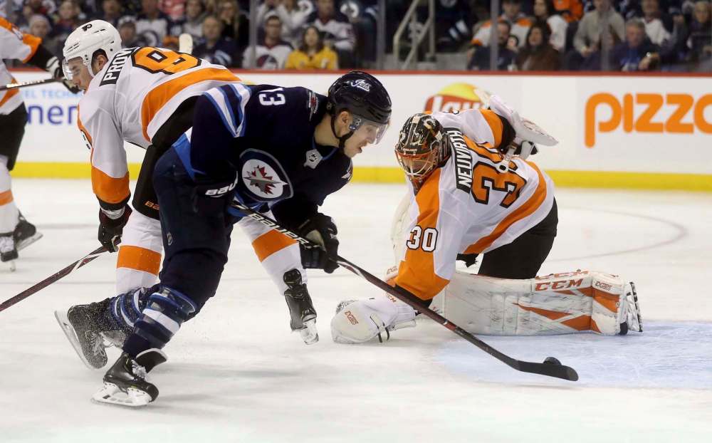 Trevor Hagan / The Canadian Press
Winnipeg Jets' Brandon Tanev (13) scores on Philadelphia Flyers' goaltender Michal Neuvirth (30) after getting past Ivan Provorov (9) during second-period action in Winnipeg Sunday.