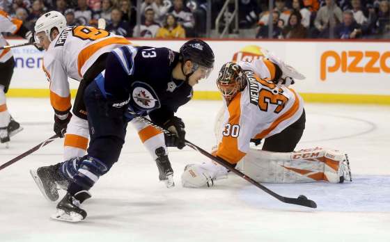 Trevor Hagan / The Canadian PressWinnipeg Jets' Brandon Tanev (13) scores on Philadelphia Flyers' goaltender Michal Neuvirth (30) after getting past Ivan Provorov (9) during second-period action in Winnipeg Sunday.