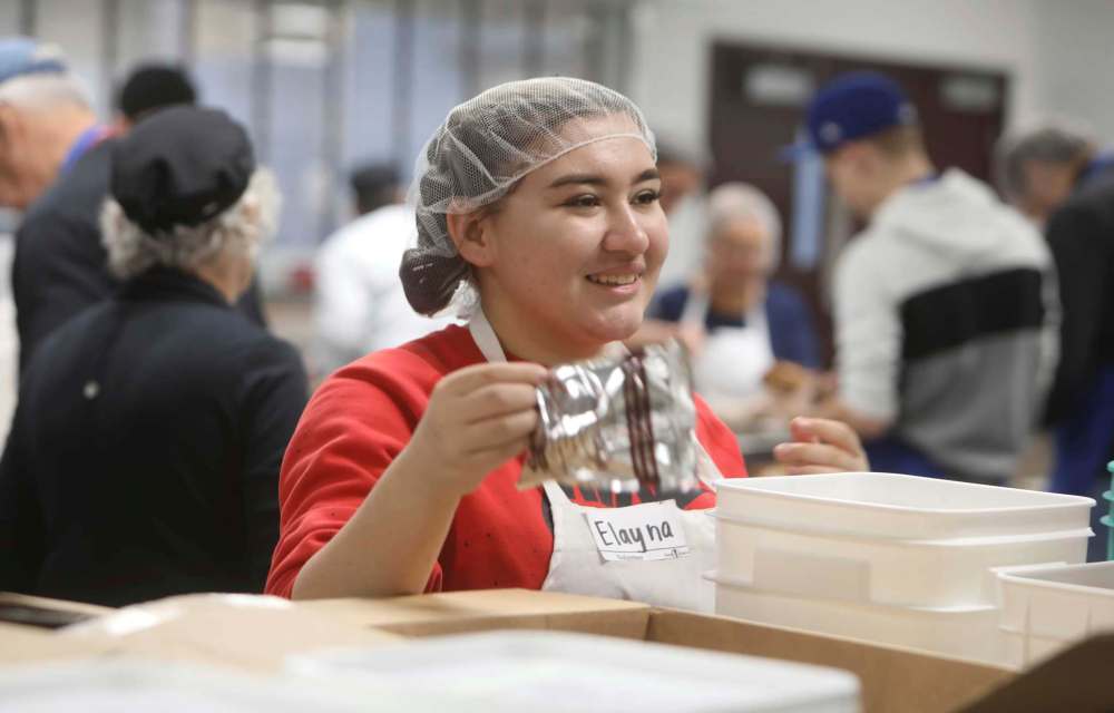 Tec Voc student Elayna La Porte helps prep a meal at Siloam Mission.