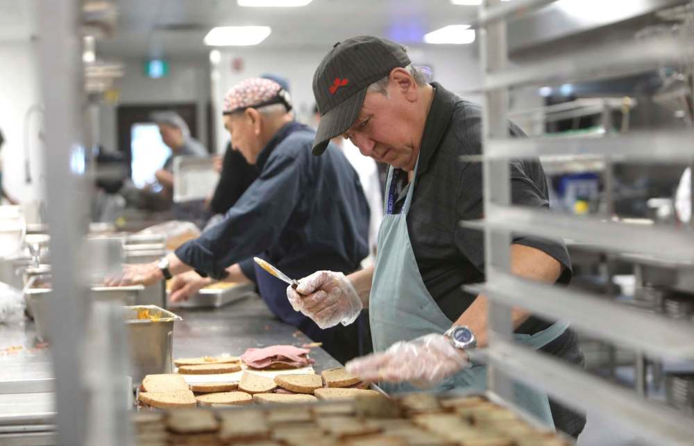 Volunteer Tim Marceniuk prepares sandwiches.