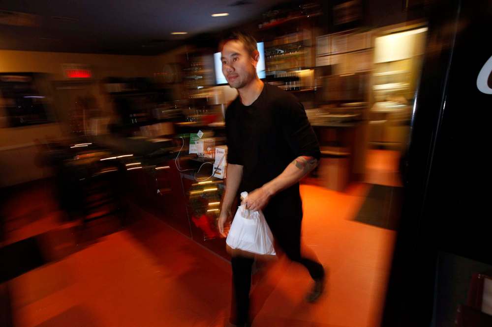 Anou Konmanisvong hustles a take-out order.