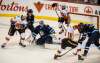 Jets' goalie Connor Hellebuyck has his eyes on the puck as Calgary scrambles in front of Winnipeg's net. (David Lipnowski / Winnipeg Free Press)