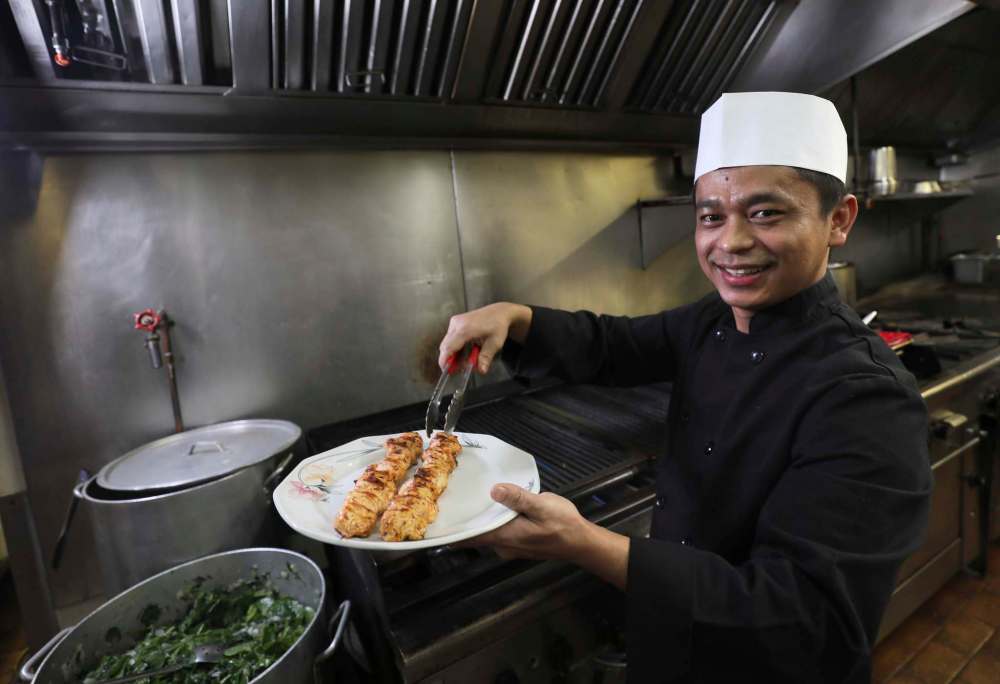 Head chef Rem Lian serves up some chicken souvlaki.
