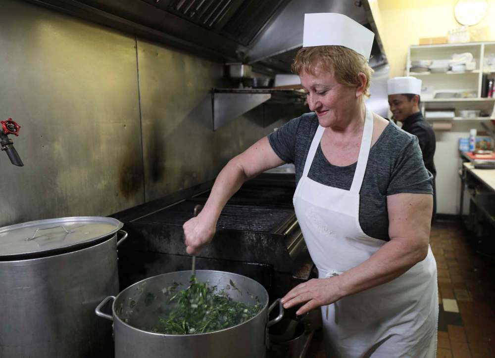 Sous chef Anna Peta with a pot of spanokopita.