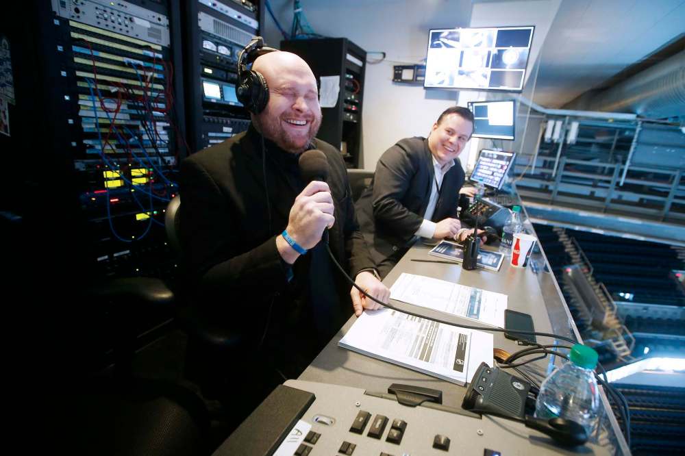 JOHN WOODS / WINNIPEG FREE PRESS
Kyle Balharry (right), senior director of game production for True North, says Jay Richardson’s powerful voice has the ability to excite the crowd without resorting to screaming.