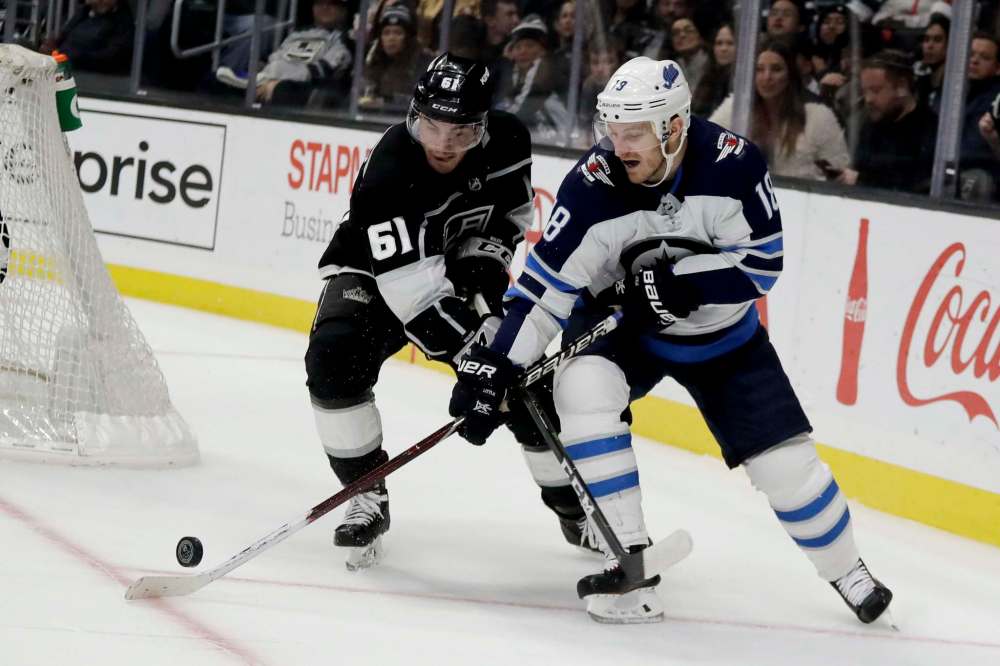 Chris Carlson / The Associated Press
Winnipeg Jets centre Bryan Little, right, vies for the puck against Los Angeles Kings defenseman Sean Walker during the third period of NHL hockey.