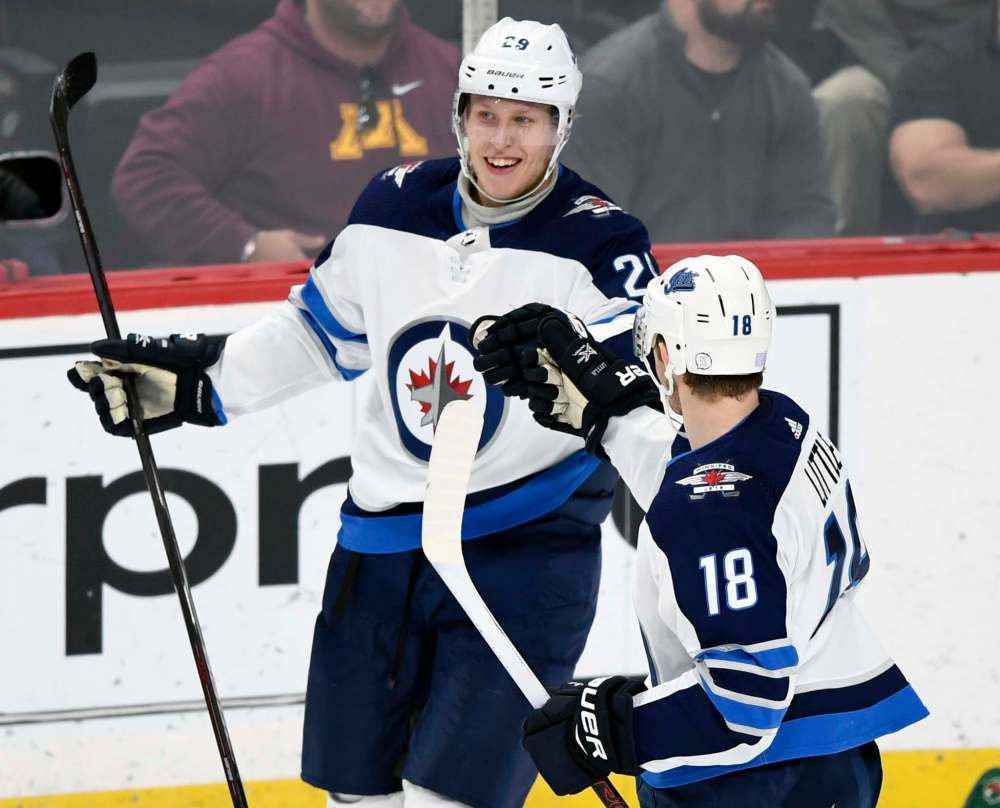 Hannah Foslien / The Associated Press
Winnipeg Jets’ Bryan Little congratulates right wing Patrik Laine on a goal against the Minnesota Wild during the first period of an NHL hockey game in November in St. Paul, Minn.