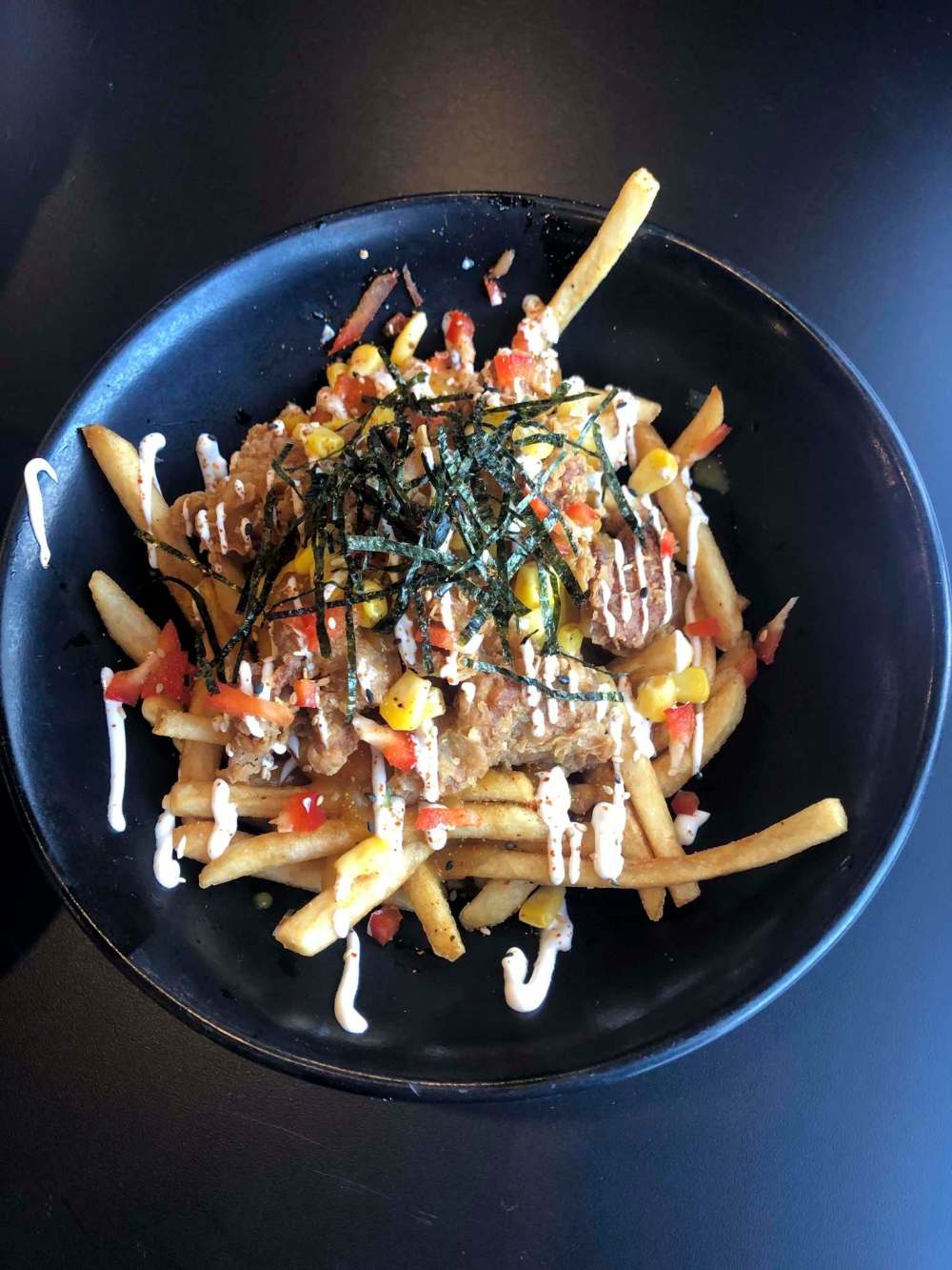 ERIN LEBAR / WINNIPEG FREE PRESS
More than 70 Winnipeg restaurants are participating in La Poutine Week, including Kyu Bistro, with its Japanese Curry Fried Chicken Poutine.