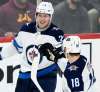 (AP Photo/Hannah Foslien)
Winnipeg Jets' Bryan Little, right, has nothing but words of encouragement for young linemate Patrik Laine.