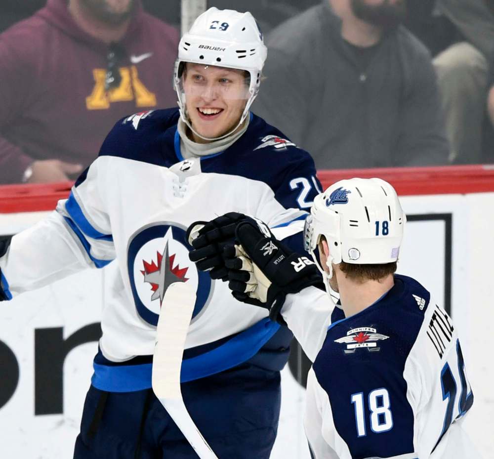 (AP Photo/Hannah Foslien)
Winnipeg Jets' Bryan Little, right, has nothing but words of encouragement for young linemate Patrik Laine.