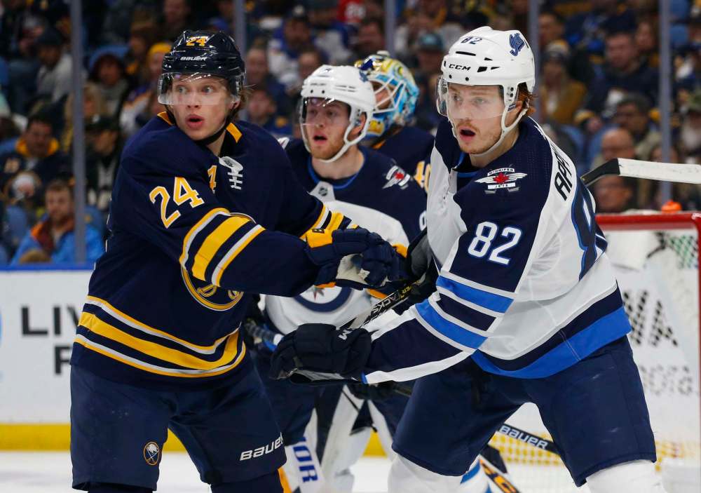 Jeffrey T. Barnes / The Associated Press
Buffalo Sabres defenseman Lawrence Pilut (24) and Winnipeg Jets forward Mason Appleton (82) battle for position during the second period of an NHL hockey game, Sunday in Buffalo N.Y.