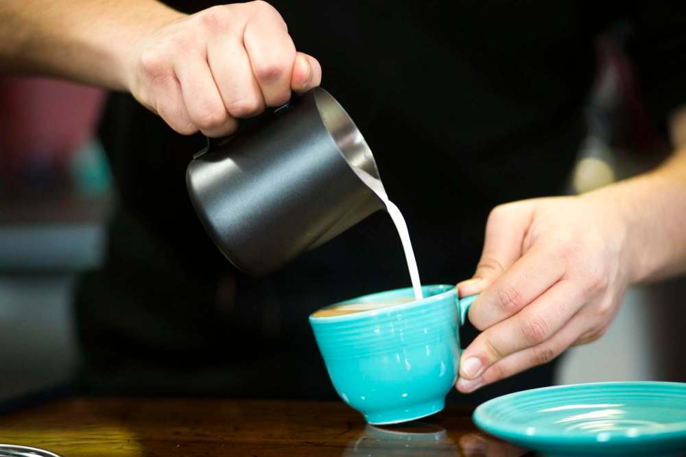 Quinton Delorme, barista at Modern Coffee, makes drinks at the café.