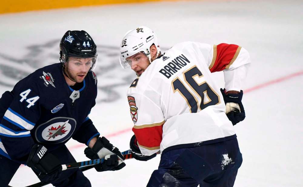 Josh Morrissey defends against Florida Panthers' Aleksander Barkov in Helsinki. (Martti Kainulainen / Lehtikuva Files)