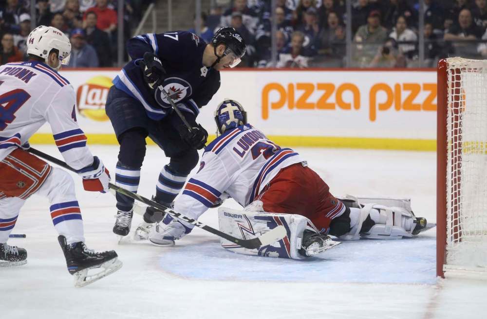 Trevor Hagan / The Canadian Press files
Jets centre Adam Lowry’s scoring attempt is stopped by Rangers goalie Henrik Lundqvist on Tuesday.