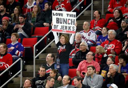 Chris Seward / The Associated Press
A Carolina Hurricanes fan holds a sign saying she loves this 'Bunch of Jerks,' a reference to the team during. Don Cherry said the Hurricanes were a 'bunch of jerks,' for the postgame celebrations that the team does when it wins at home.