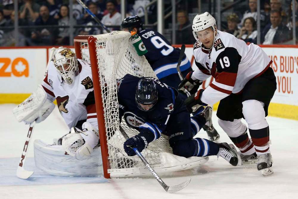 John Woods / The Canadian Press files
Doan (right) checks Jets forward Nic Petan into the back of the net during a 2017 tilt with the Jets.