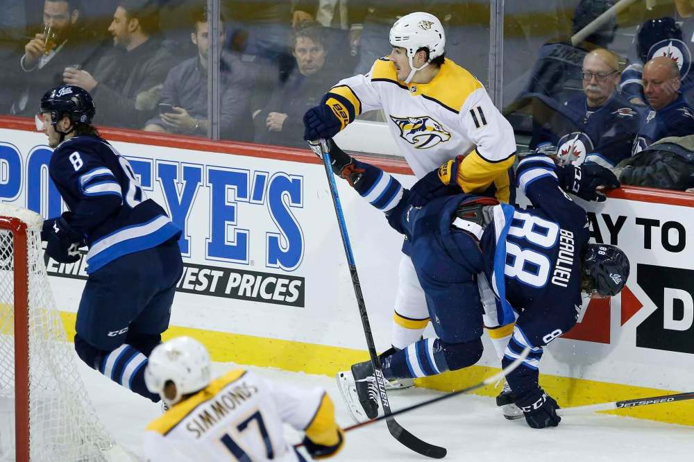 John Woods / The Canadian Press
Predators newcomer Brian Boyle blasts Jets newbie Nathan Beaulieu during Winnipeg’s 5-3 win Friday night.