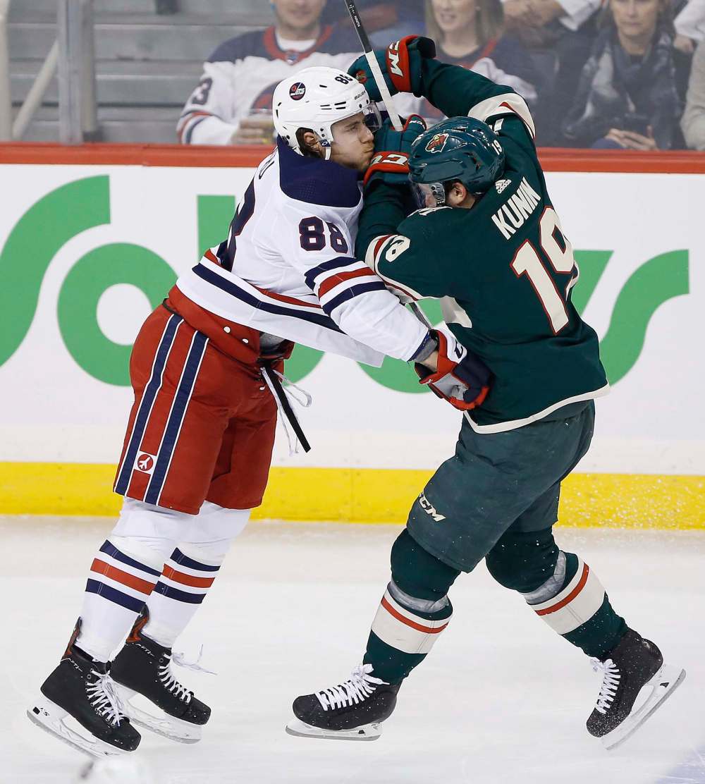 JOHN WOODS / WINNIPEG FREE PRESS
Beaulieu, left, stops Minnesota Wild's Luke Kunin during the first period in Winnipeg on Tuesday. Jets head coach Paul Maurice believes Beaulieu’s game is more suited for the rugged, big-body style of the Western Conference.