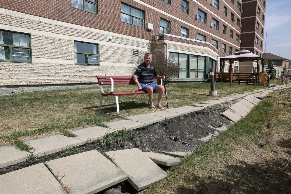 Columbus House resident Tom Ellis outside the co-op seniors home following the collapse of a sidewalk behind 404 Desalaberry Ave. last year. (Mike Deal / Winnipeg Free Press files)