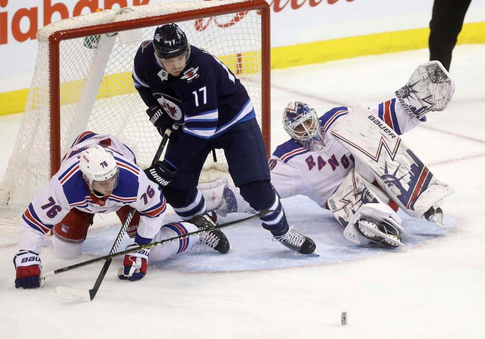 Adam Lowry is eligible to return from a two-game suspension, but is sick and his status Friday is in doubt. (Trevor Hagan / The Canadian Press files)
