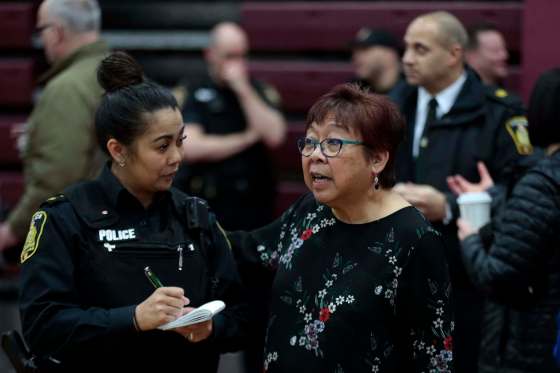 PHIL HOSSACK / WINNIPEG FREE PRESSPerla Javate (right) talks with a city police officer at a community forum at Daniel McIntyre Collegiate Institute on Thursday evening.