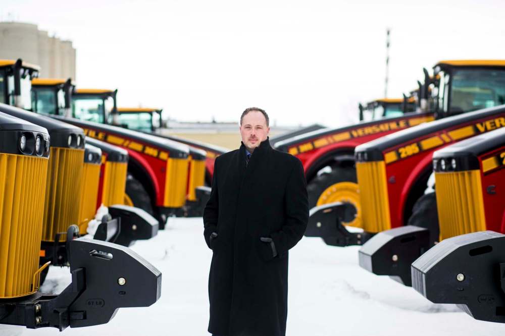 MIKAELA MACKENZIE / WINNIPEG FREE PRESS
Buhler vice-president of sales and marketing Adam Reid, seen with Versatile tractors on Monday, says the company does not expect it will need to increase staff in the short term in the wake of its partnership with Japan’s Kubota Corp.