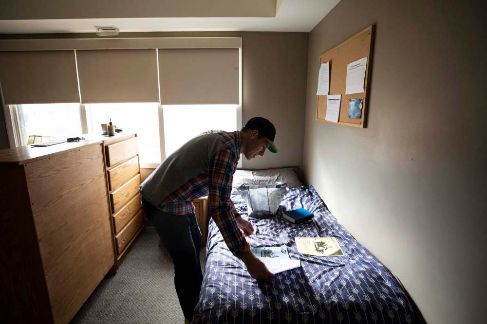 Client Mike Green prepares his work in his room.