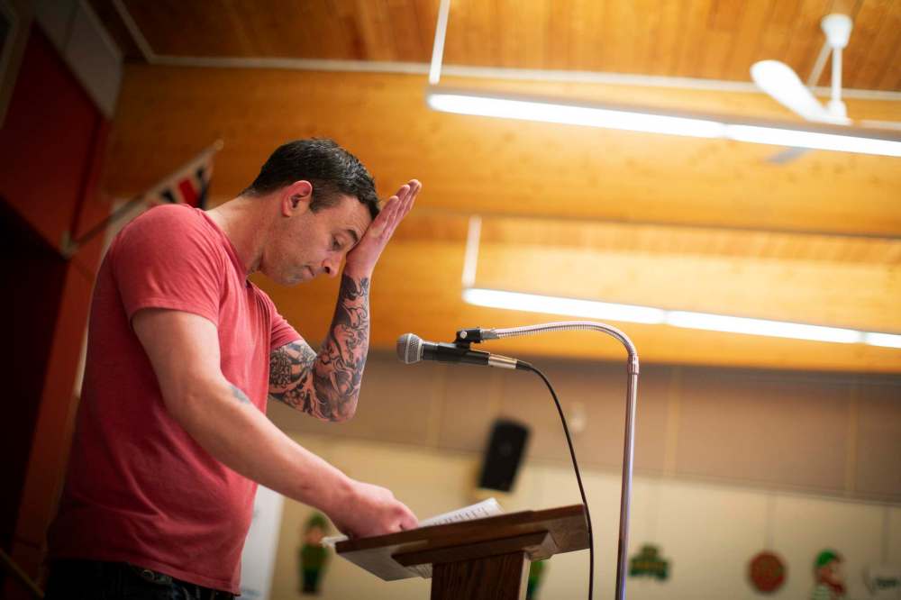 Photos by Todd Korol / The Winnipeg Free Press
Just in day three, client Scott McGillawee pauses while reading the AA 12-step program during a grad ceremony.>